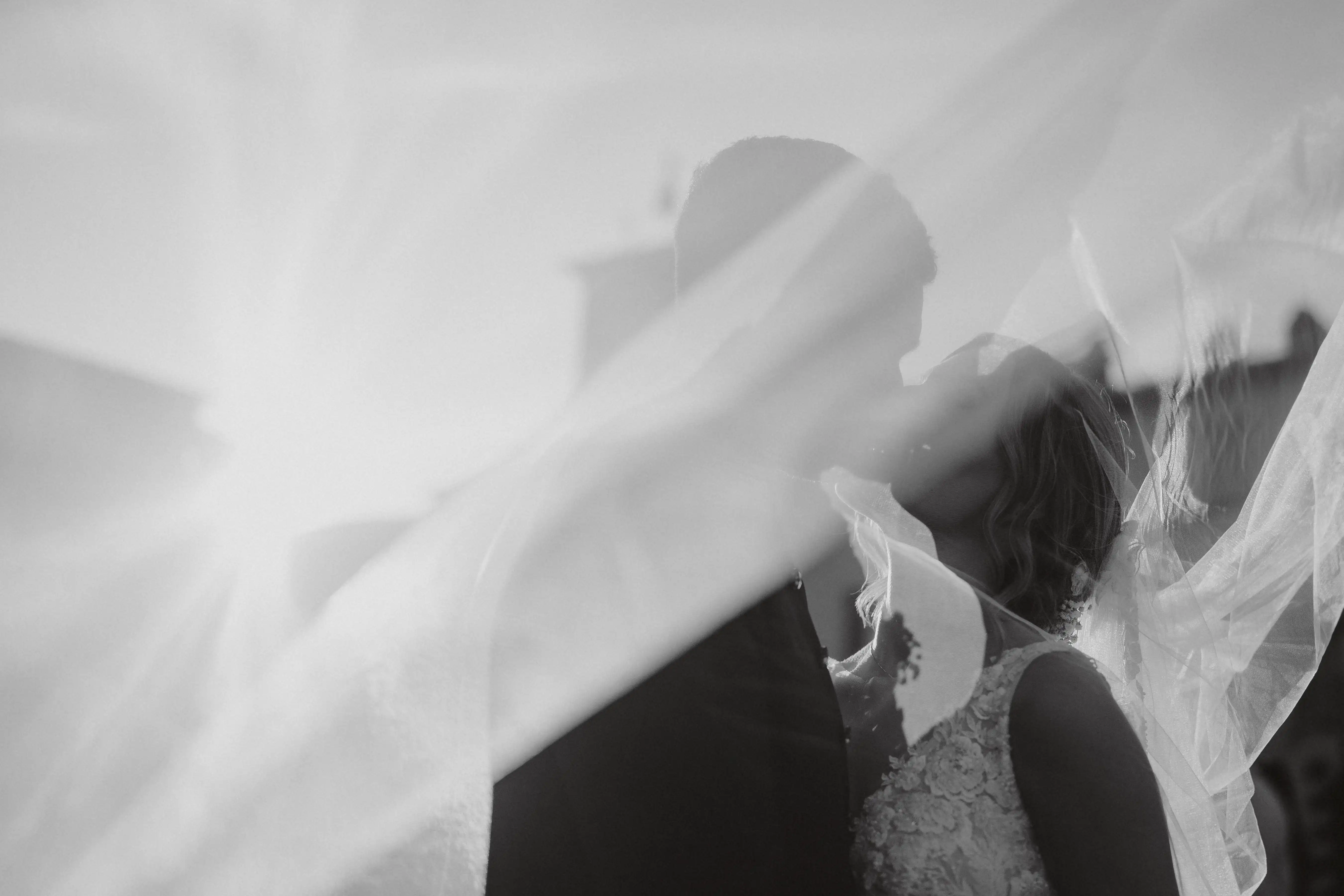 Kiss behind the bridal veil